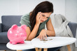 © Andrey Popov - Happy Woman Emptying Her Piggybank Savings