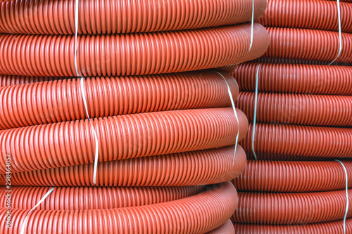 Coils Of New Red Plastic Pipe With Rain Drops Red Plastic Tubing