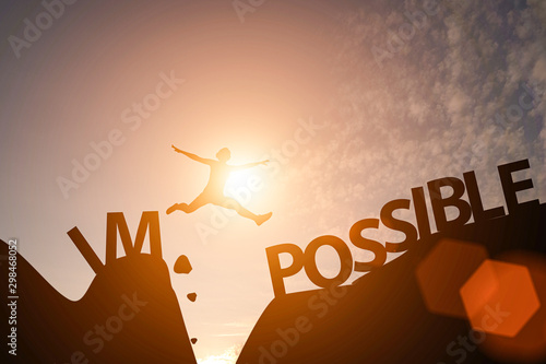 Man jump between impossible wording and possible wording on mountain Tableau sur Toile
