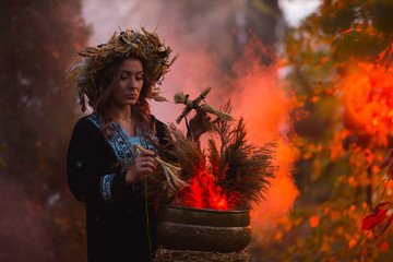 Woman sitting in burning pentagram circle, magic.