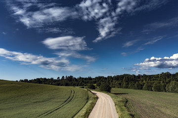 Cloudy sky over countryside landscape.