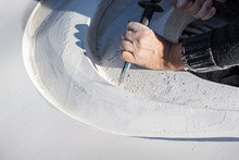 Closeup Of An Artist Carving Curves Into A White Stone
