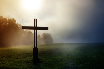 cross out in the coutry during a foggy morging and mystic setting