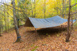 Bushcraft tarp camp shelter in the Blue Ridge Mountain Wilderness near Asheville, North Carolina. Primitive campsite in the forest. Survival gear.