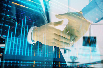 Multi exposure of financial graph on office background with two businessmen handshake. Concept of success in business