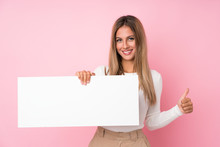 Young Blonde Woman Over Isolated Pink Background Holding An Empty White Placard For Insert A Concept