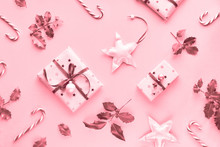 Festive Monochrome Pink Christmas Background With Pink Gift Boxes, Stripy Candy Canes, Trinkets And Decorative Stars, Geometric Creative Flat Lay