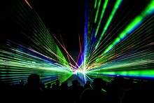 Laser Show Rays Stream. Very Colorful Show With A Crowd Silhouette And Great Laser Rays At Youth Party Festival