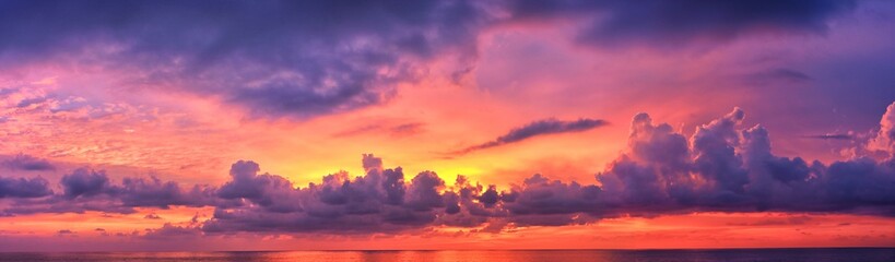 phuket beach sunset, colorful cloudy twilight sky reflecting on the sand gazing at the indian ocean,