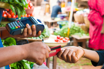 holding a pos machince and receiving of credit card in a market