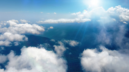Wall Mural - flying through heavenly beautiful sunny cloudscape. picturesque of white fluffy clouds moving softly