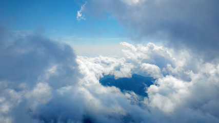 Wall Mural - flying through heavenly beautiful sunny cloudscape. amazing of white fluffy clouds moving softly on 