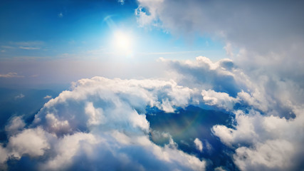 Wall Mural - flying through heavenly beautiful sunny cloudscape. amazing of white fluffy clouds moving softly on 