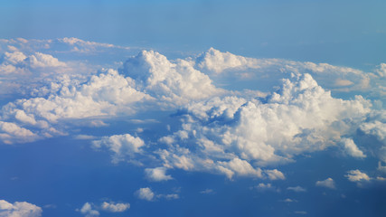 Wall Mural - flying over beautiful sunny cloudscape. amazing panorama of dense fluffy clouds moving from right to