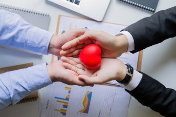 two businessman holding red heart.Heart of success.Concepts of success