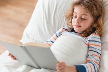 Wall Mural - Boy reading  a book