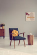 © Photographee.eu - Yellow knot pillow on trendy vintage armchair in empty room