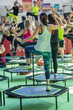© GioRez - Mini Rebounder Workout - Girls doing Fitness Exercise in Class at Gym with Music and Teacher on Stage