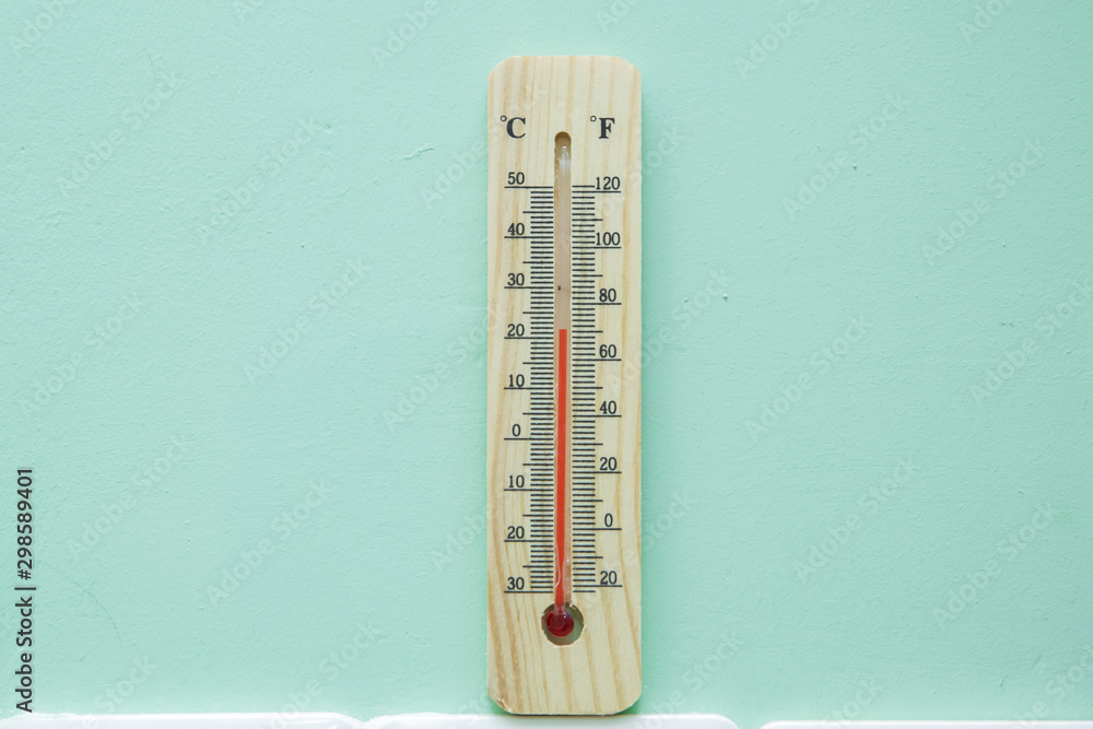 Blank space for writing . Thermometer on green background. Measuring temperature. Air temperature plus 21 degrees . Thermometer thermostat instrument to measure air temperature .