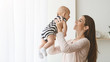© Prostock-studio - Mom playing with her baby lifting him up in air