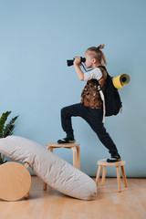 Little boy playing hiker at home. Looking through binoculars into distance