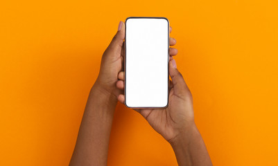Fototapete - Black hands holding smartphone with blank screen for mockup