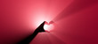 Symbol of love with a hand gesture. Red spotlight in the background.