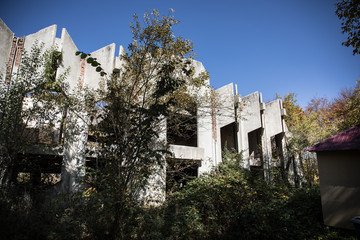 Autumn forest and old soviet building. Azerbaijan Ganja