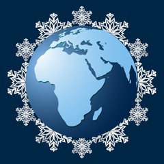 Planet Earth on a background of snowflakes, a symbol of the coming winter. The onset of the cold season. Snowfall and cold season. Vector illustration.