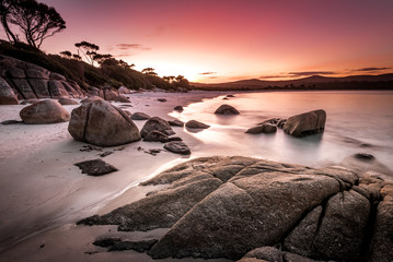 Dreamlike sunset on Binalong Bay in Tasmania, also called the Bay of Fires, a picturesque landscape and coastline of Australia's largest island, on a mild spring day on the east coast of Tassie