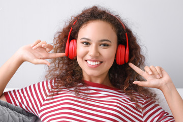 Poster - Beautiful African-American woman listening to music at home