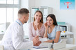 © Pixel-Shot - Lesbian couple visiting male gynecologist in clinic