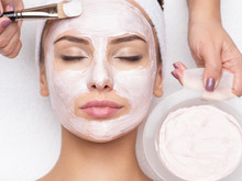 Woman Receiving  Facial Mask In Spa Beauty Salon