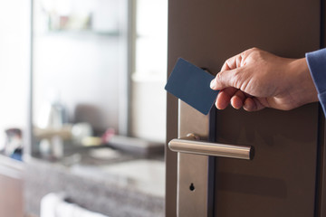 hand touch keycard on hotel door