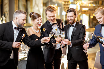 Well-dressed people celebrating New Year indoors