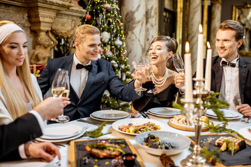 Wall Mural - Elegantly dressed people celebrating New Year holiday indoors