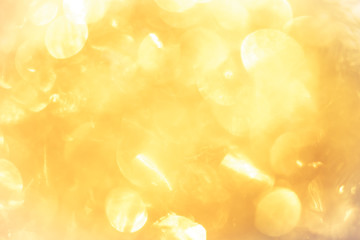 Wall Mural - golden color blurred abstract background. yellow bokeh christmas blurred beautiful shiny Christmas lights.