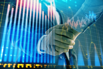 Multi exposure of forex graph on abstract background with two businessmen handshake. Concept of success on stock market