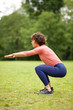 © mimagephotos - sIde of active woman stretching outdoors in park