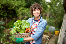 Smiling Farmer With Bunch Of Vegetables In Basket