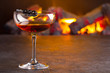 © kateholms - Manhattan cocktail on fireplace background