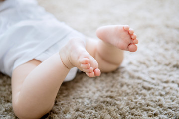 Blurred background of newborn baby feet on carpet