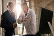 © Drazen - Doctor and senior businessman cooperating while working on a computer at clinic.
