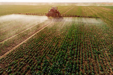 Tractor Spraying Fertilizer Or Pesticides On Field With Sprayer