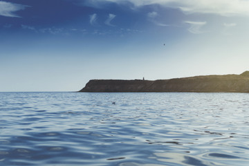 Wall Mural - Sea view with an island in the distance.