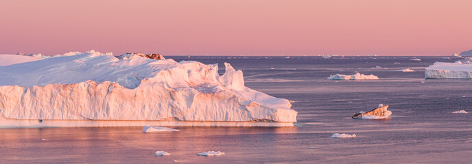 Wall Mural - Global Warming and Climate Change - Icebergs and ice from melting glacier in icefjord in Ilulissat, Greenland. Aerial photo of arctic nature ice landscape. Unesco World Heritage Site. Panoramic banner
