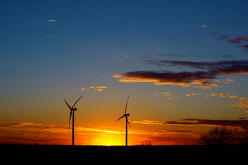 wind turbines at sunset