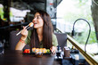 © F8  \ Suport Ukraine - Beautiful young girl enjoying sushi in a cafe on a sunny day