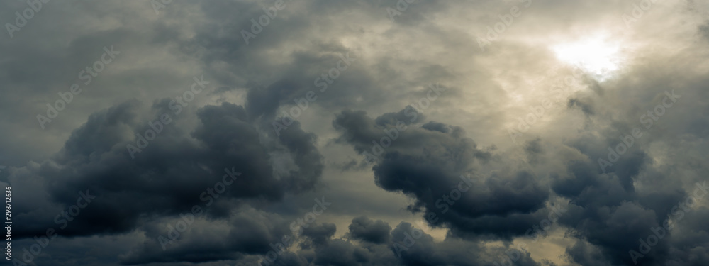 dramatic mystical sky with gray heavy clouds and faint back sunlight and lumen. artistic panoramic picture for the original background, layout or decoration - obrazy, fototapety, plakaty 