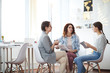 © Seventyfour - Portrait of three contemporary women discussing photographs sitting at table in cozy apartment, copy space
